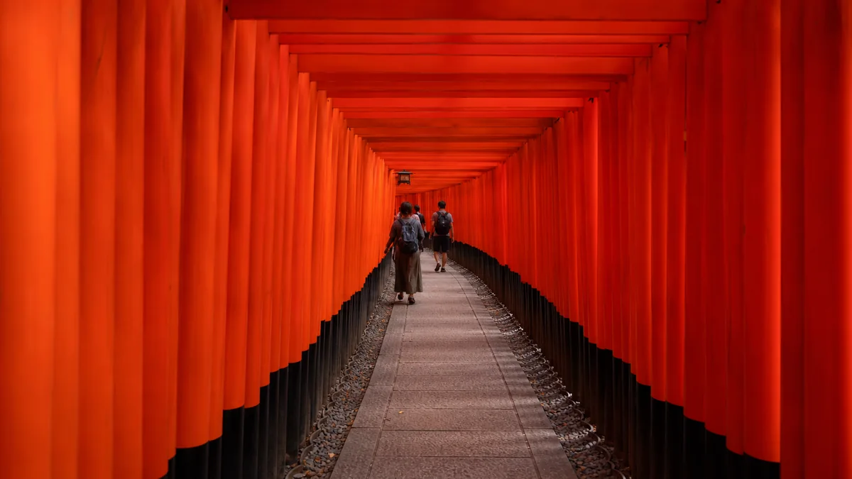 Fushimi Inari vermilion torii gate path in Kyoto in the early morning